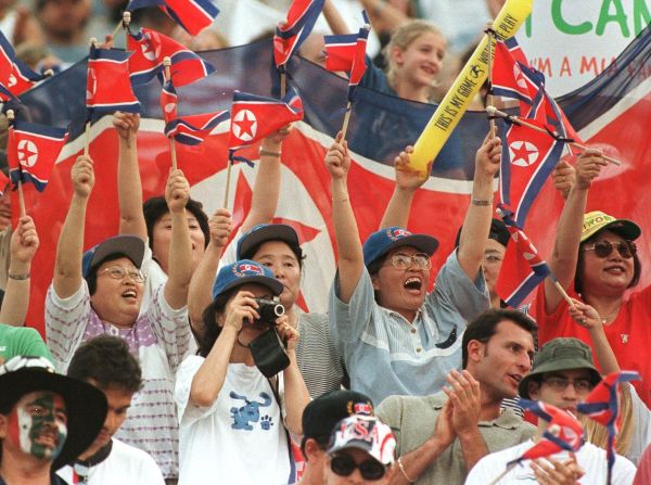 North Korea fans cheer before the team's match against the USA in Massachusetts. The visitors would fall to a 3-0 defeat and failed to qualify for the knockout stages.  