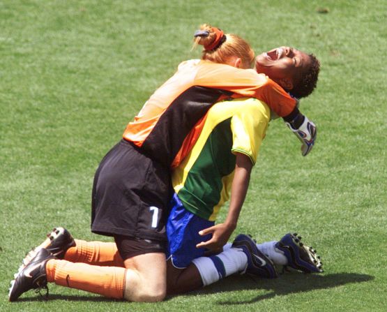 Brazil's Formiga (R) is hugged by goalie Maravihla after her game-winning shootout goal during the third-place playoff at the Rose Bowl as Brazil defeated Norway 5-4 on penalty kicks.