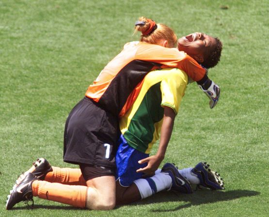 Brazil's Formiga (R) is hugged by goalie Maravihla after her game-winning shootout goal during the third-place playoff at the Rose Bowl as Brazil defeated Norway 5-4 on penalty kicks.