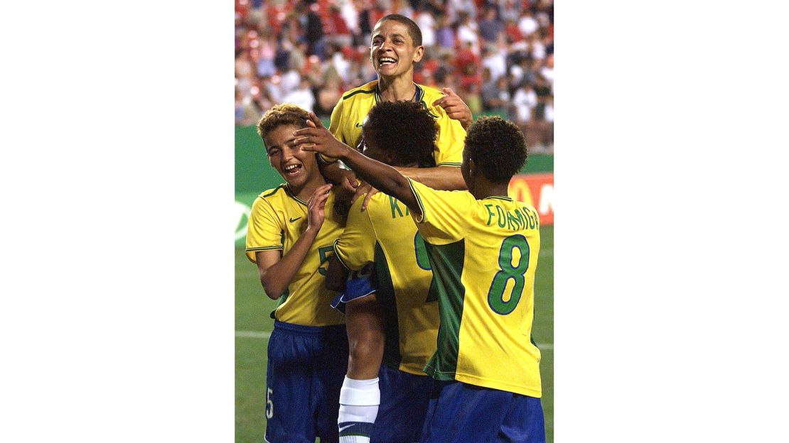 Sissi (C) is engulfed by teammates after the quarterfinal victory over Nigeria. 