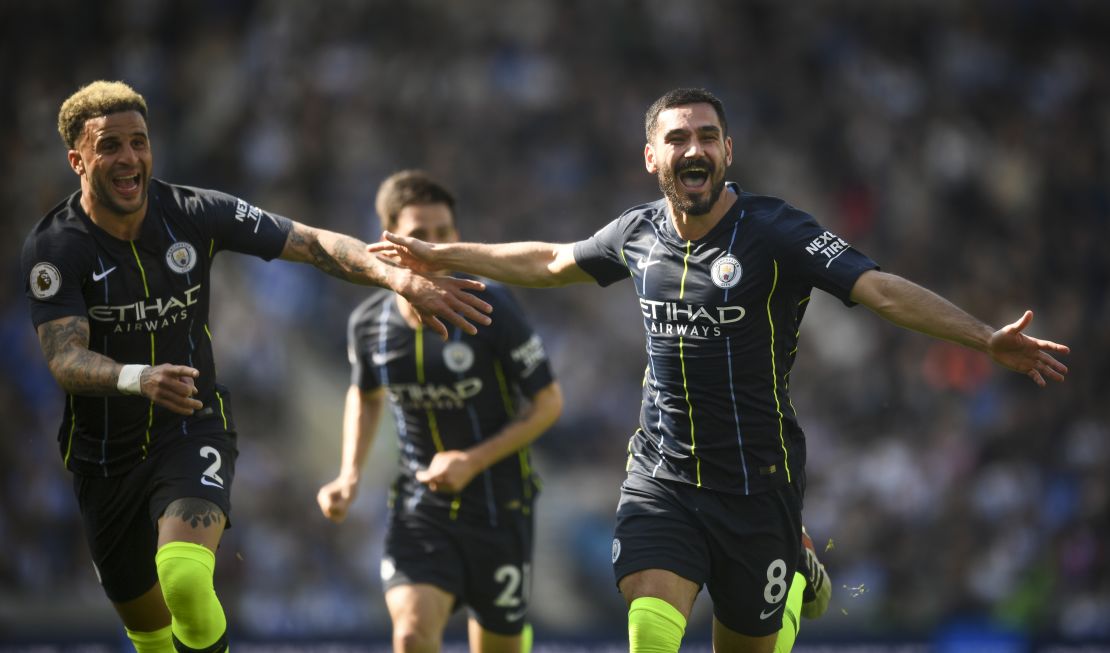 City's Ilkay Gundogan and Kyle Walker celebrate after the Turkish player scored City's fourth goal to seal the match against Brighton. 