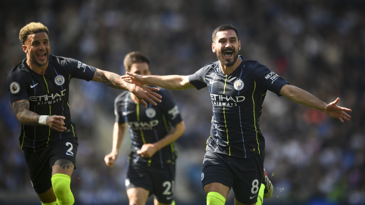 City's Ilkay Gundogan and Kyle Walker celebrate after the Turkish player scored City's fourth goal to seal the match against Brighton. 
