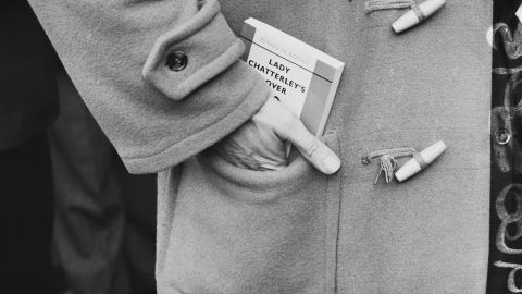 A man carries a copy of D. H. Lawrence's book, "Lady Chatterley's Lover" soon after it was first published in full in the UK. 