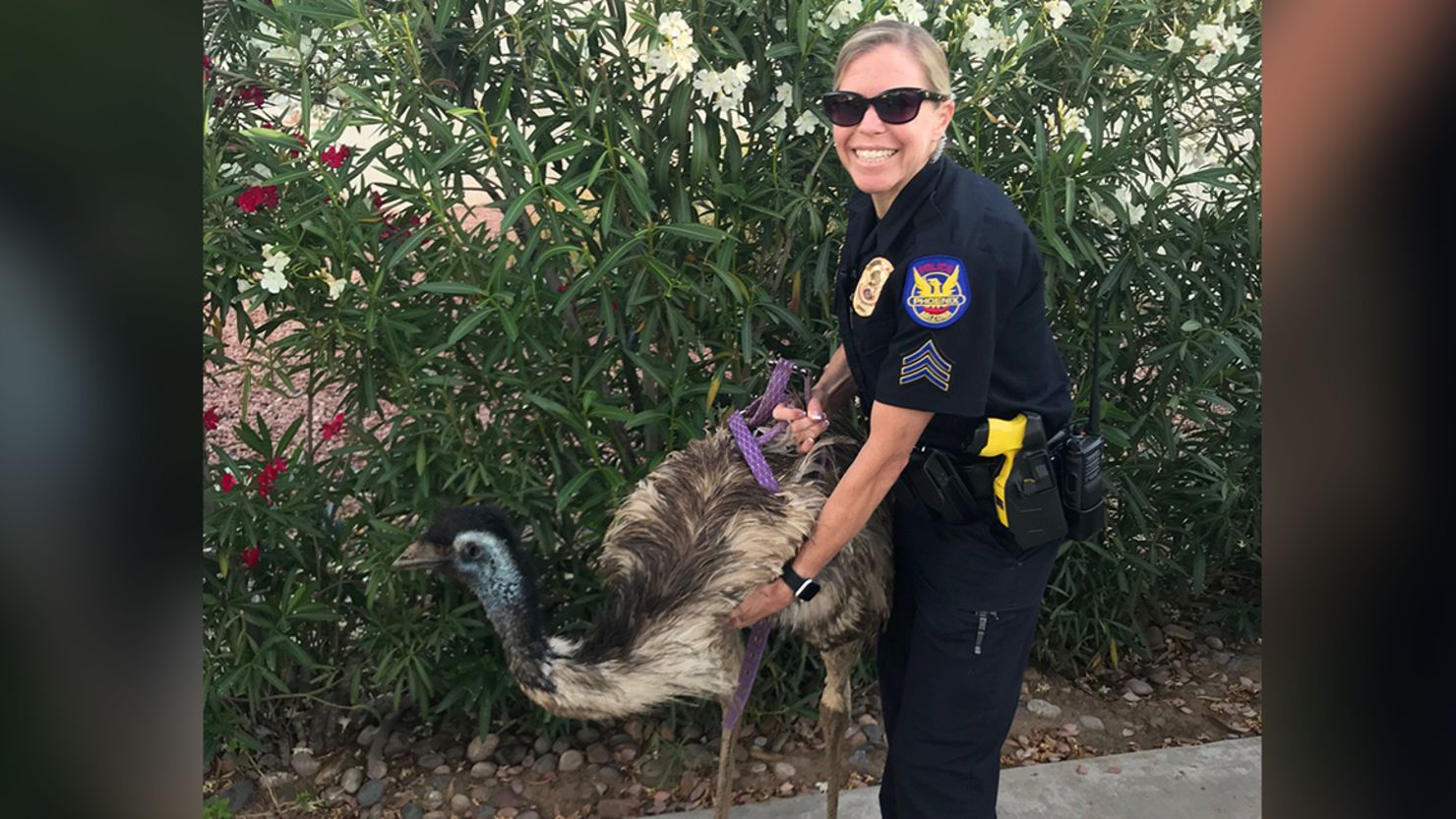 A Phoenix police officer poses with the escapee.