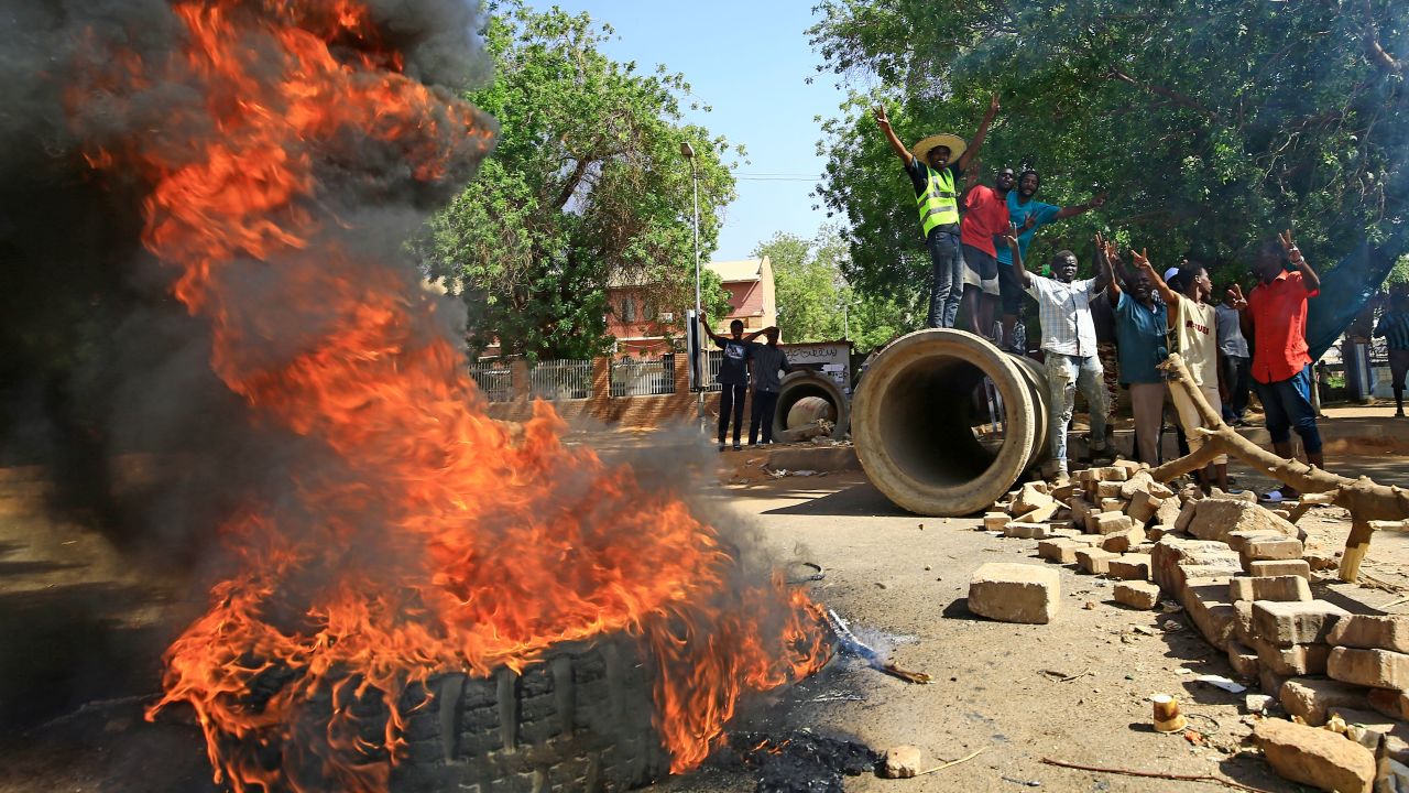 Sudanese protesters burn tires as they block Nile Street, a major thoroughfare, on Monday.