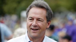 FILE - In this Aug. 16, 2018, file photo, Montana Gov. Steve Bullock walks down the main concourse during a visit to the Iowa State Fair in Des Moines, Iowa. Former Vice President Joe Biden and several nationally known senators are commanding most of the attention in Democrats' early presidential angling, but there are several governors and mayors, including Bullock, eyeing 2020 campaigns, as well. (AP Photo/Charlie Neibergall, File)