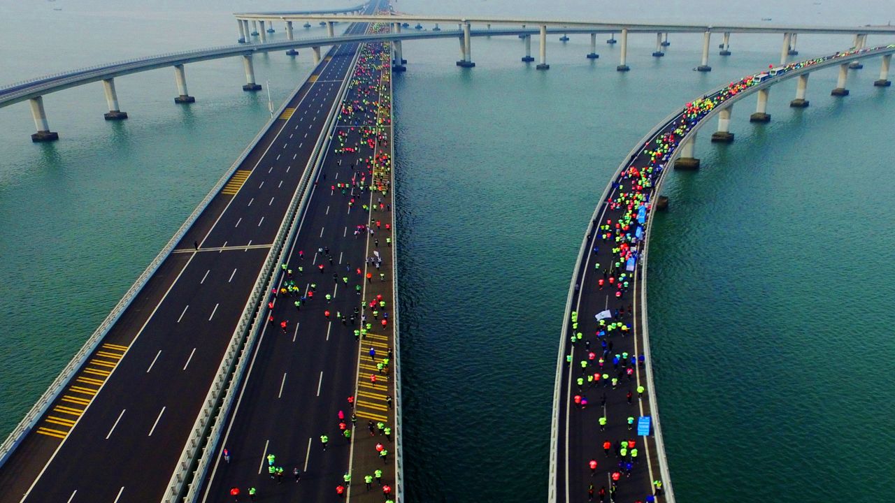 This photo taken on November 19, 2017 shows participants crossing the Jiaozhou Bay Bridge as they compete in the 2017 Qingdao International Marathon over the sea in Qingdao in China's eastern Shandong province. 