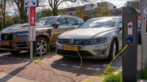Volvo and VW electric cars recharge at a charging station in Amsterdam. 