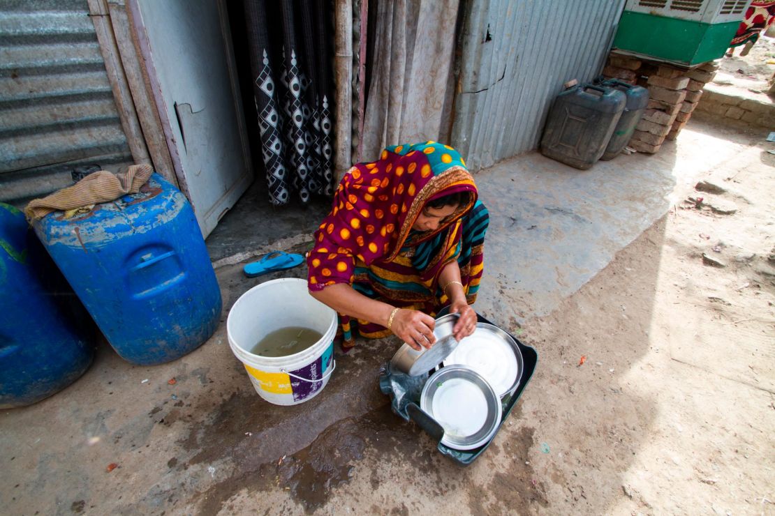 Residents of Vasant Kunj slum try to stretch water as much as possible by reusing dirty water to wash cooking utensils.