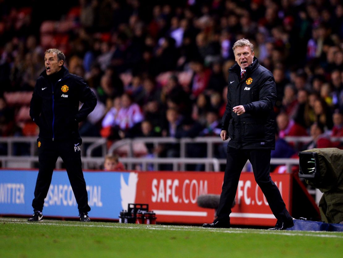 Moyes, then manager of Manchester United (R), with then assistant coach Phil Neville, who is now England Women's manager.