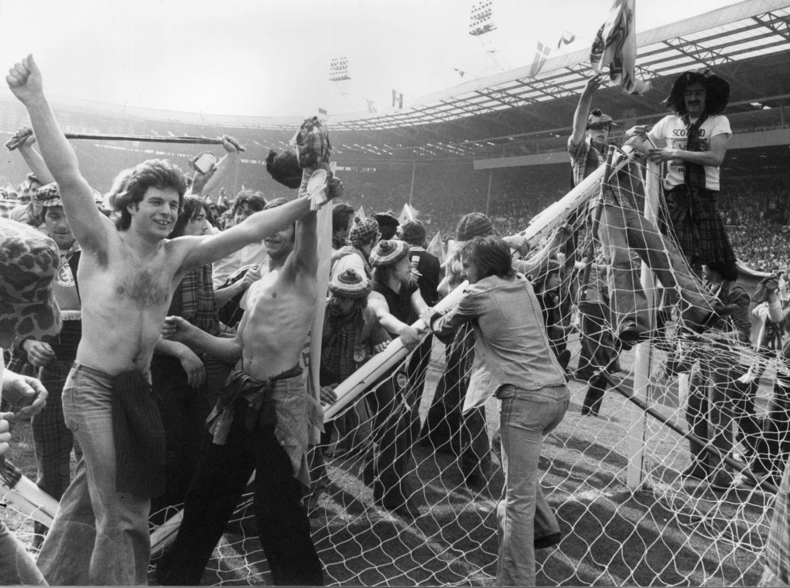 Scottish football fans invading the pitch and pulling down goalposts after Scotland's men beat England 2-1 at Wembley Stadium in 1977. 