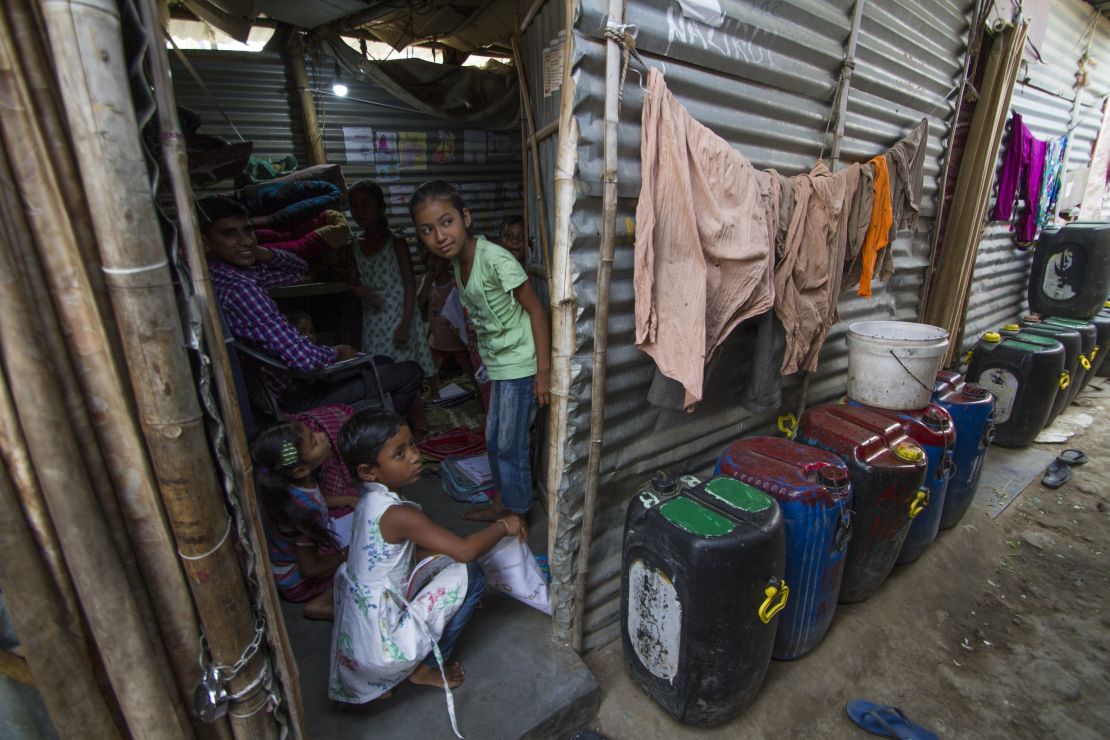 Water containers line every lane and take up every available space in the slum. 