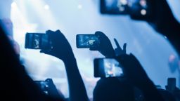 Audience members record and livestream on their smartphones at a concert in Sao Paulo, Brazil.