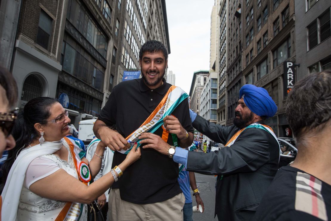 Sim Bhullar is flanked by his parents as he takes part as a marshal during the Indian Day Parade on August 17, 2014 in New York.