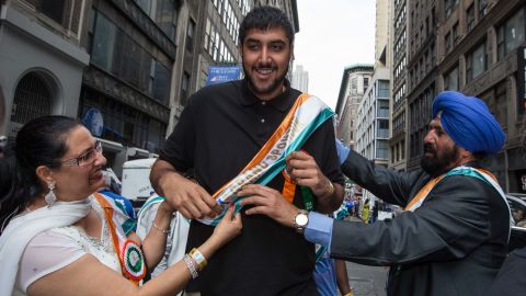 Sim Bhullar is flanked by his parents as he takes part as a marshal during the Indian Day Parade on August 17, 2014 in New York.