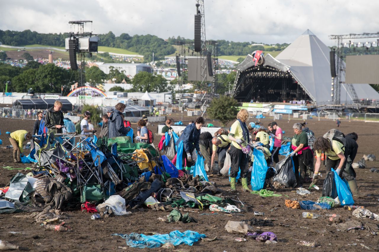 Festivals are facing mounting pressure to clean up their act, lower emissions and cut down on waste. Here are some easy ways you can enjoy a festival this summer without trashing the planet. <br /><br />Pictured: Litter collectors clearing the fields in front of the main Pyramid Stage at Glastonbury Festival in the UK. 