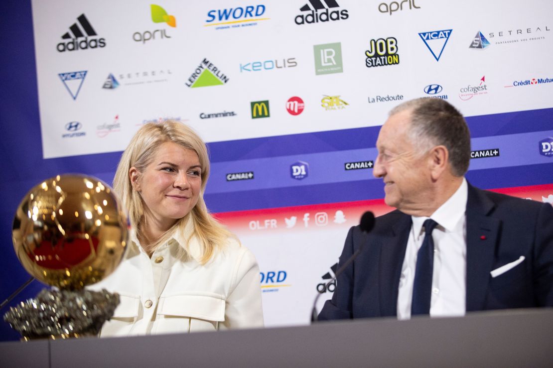Hegerberg (L) with Lyon's French President Jean-Michel Aulas.