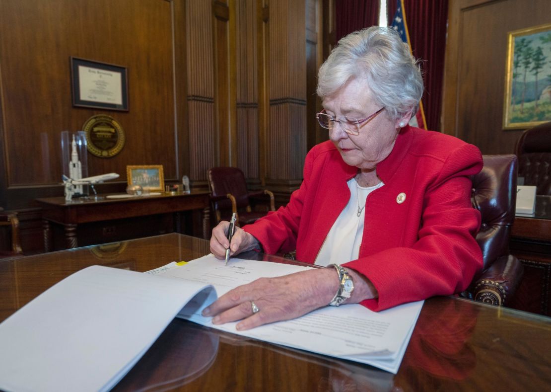 Gov. Kay Ivey signing Alabama abortion bill.