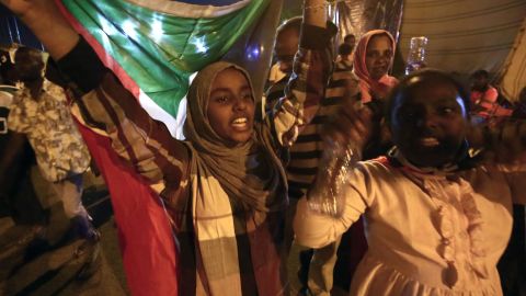 Sudanese protestors celebrate after an agreement was reached with the military council to form a three-year transition period for transferring power to a full civilian administration.