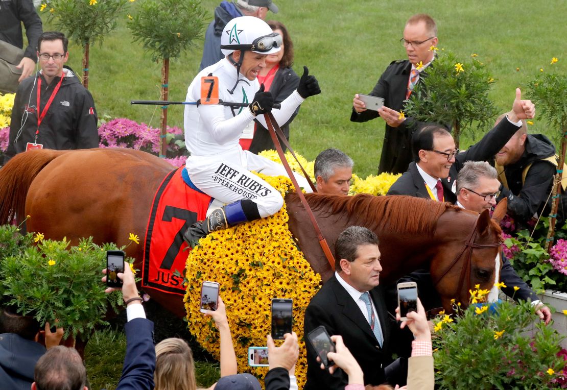 Jockey Mike Smith and racing horse Justify enter the winners circle at the 143rd Preakness Stakes. 