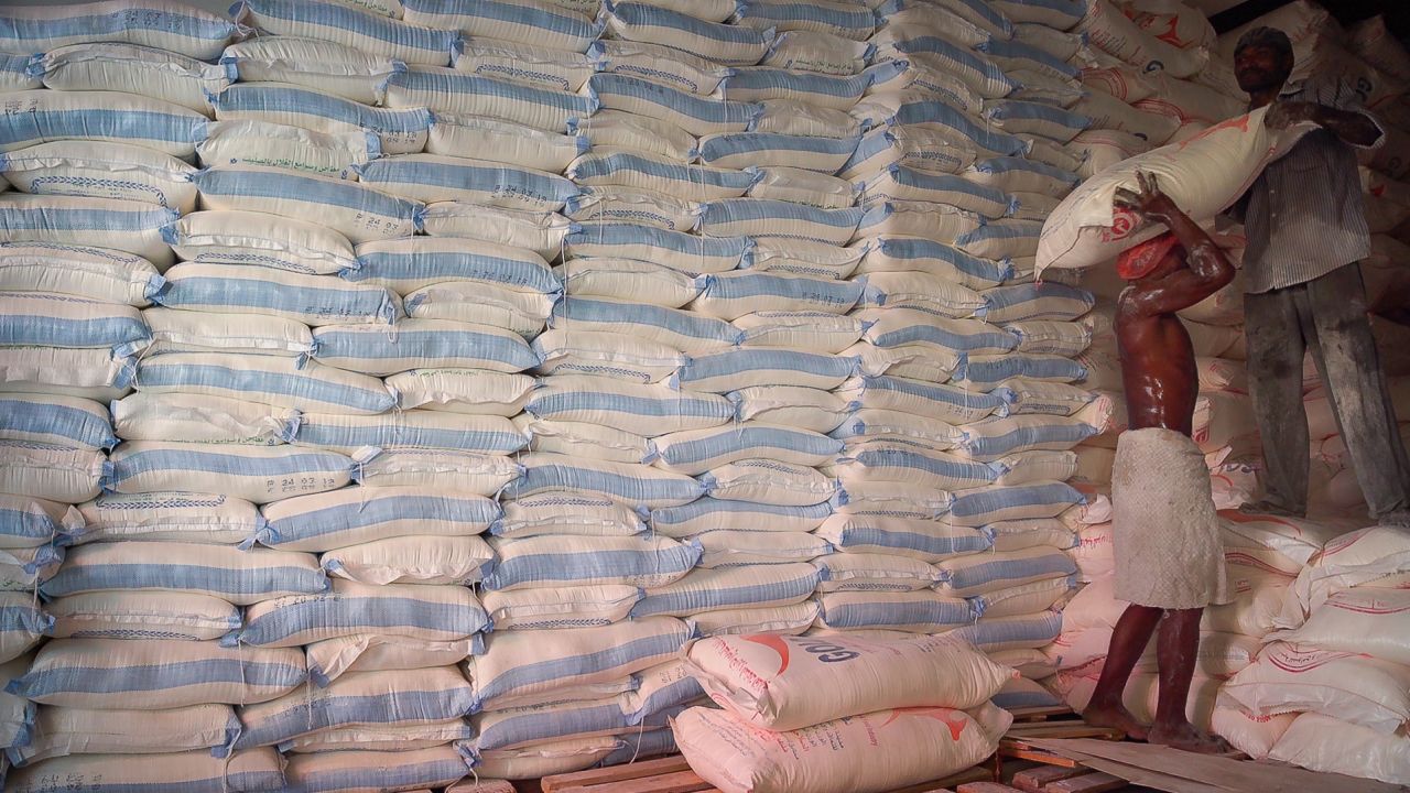 Men stack sacks of flour at a warehouse for WFP supplies in Hodeidah.