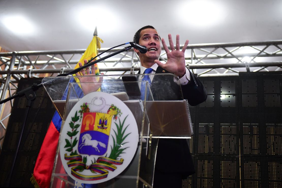 Venezuelan opposition leader and self-declared president Juan Guaido talks at a meeting in Caraca's Chamber of Commerce Auditorium.