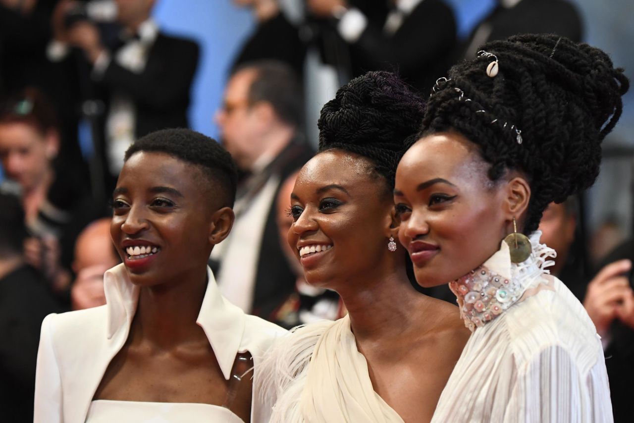 Actress Samantha Mugatsia, director Wanuri Kahiu and  actress Sheila Munyiva pose as they arrive on May 9, 2018 for the screening of the film "Rafiki" at the 71st edition of the Cannes Film Festival.