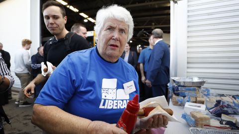 Liberal Party supporter Dorothy Dehais has a sausage during a campaign rally at Launceston airport on April 18.
