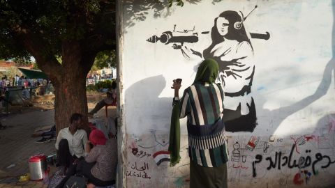 A woman paints an image of a female fighter near a protest site in Khartoum on May 2.