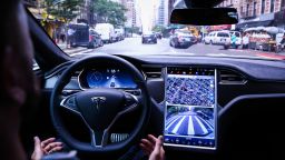 A driver rides hands-free in a Tesla Motors Inc. Model S vehicle equipped with Autopilot hardware and software in New York, U.S. on Monday, Sept. 19, 2016. The latest overhaul of the car's operating system, known as Tesla 8.0, biggest change is how Autopilot shifts towards a heavier reliance on its radar than its camera to guide the car through traffic. Photographer: Christopher Goodney/Bloomberg via Getty Images
