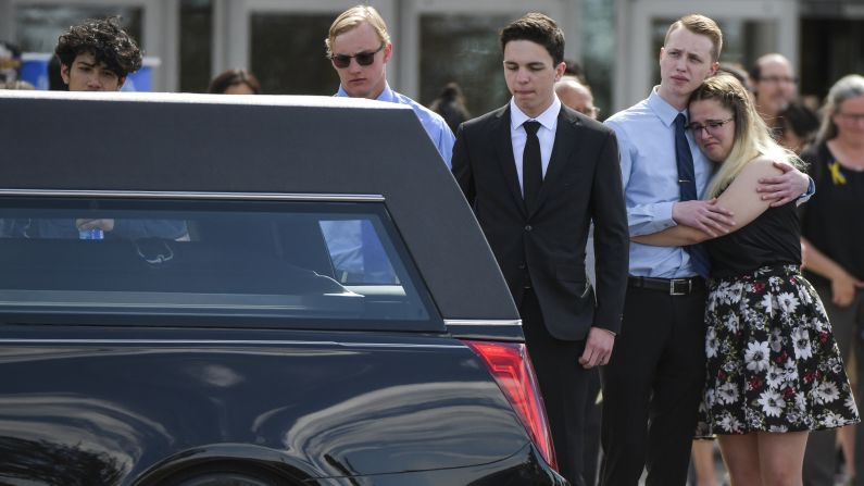 People embrace as Kendrick Castillo's casket is loaded into a hearse in Highlands Ranch, Colorado, on Wednesday, May 15. Castillo, 18, <a href="https://www.cnn.com/2019/05/15/us/kendrick-castillo-shooting-jeeps-trnd/index.html" target="_blank">was killed last week</a> while trying to stop a gunman during a school shooting.