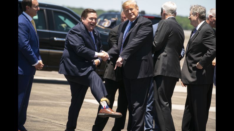 Louisiana Lt. Gov. Billy Nungesser shows off his socks to US President Donald Trump, who had just arrived in Lake Charles, Louisiana, on Tuesday, May 14.