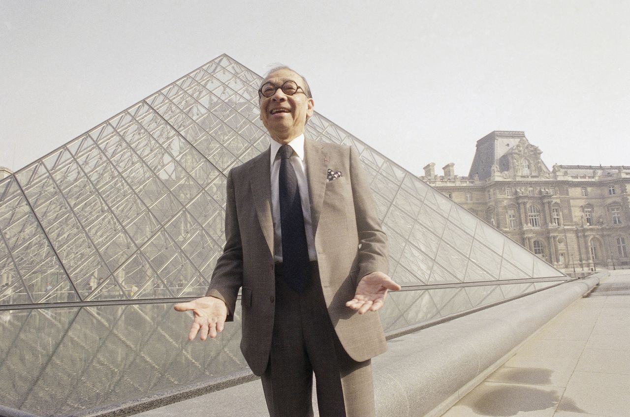 I.M. Pei bursts out laughing while posing in front of the Louvre glass pyramid prior to its inauguration by French President Francois Mitterrand on Wednesday, March 29, 1989 in Paris.