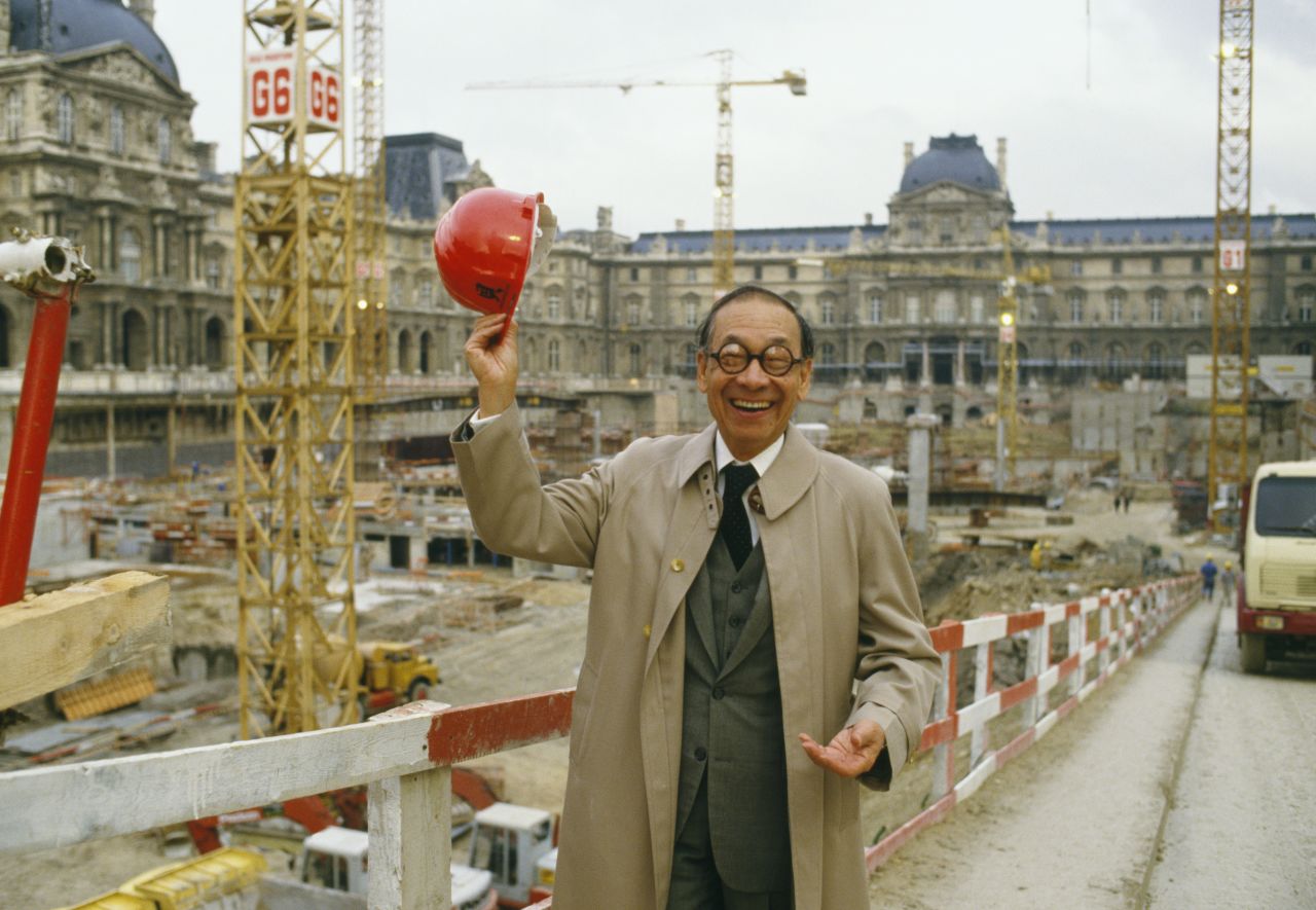 Pei raises his hard hat at the entrance of the construction site of the Louvre's glass Pyramid. The pyramid is perhaps Pei's most widely known building.