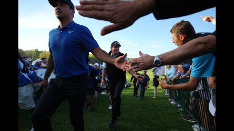 Phil Mickelson and Jason Day salute their fans as they complete solid first rounds of 1 under par.