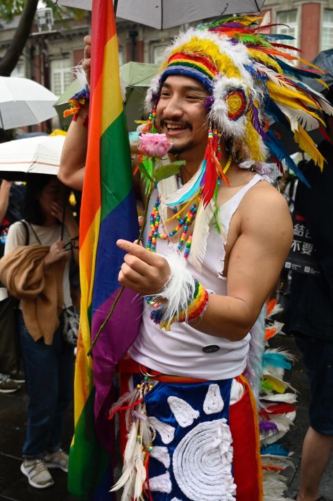 A gay rights advocate holds a flower in  support of the same-sex marriage law.