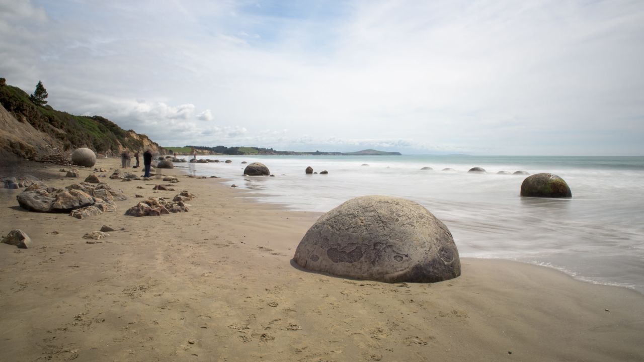 The Moeraki Boulders lie scattered along Koekohe Beach in New  Zealand's South Island.