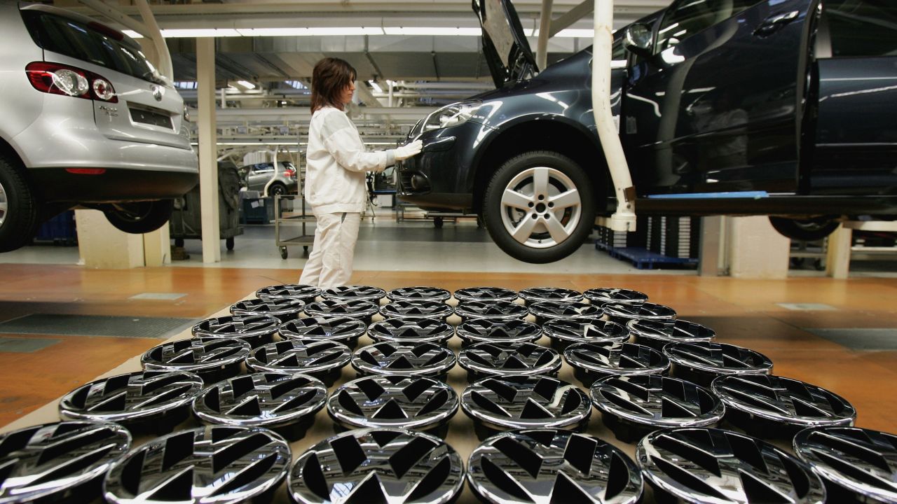 A worker stands by Volkswagen hood ornaments at the Golf production line at the Volkswagen factory in Wolfsburg, Germany.