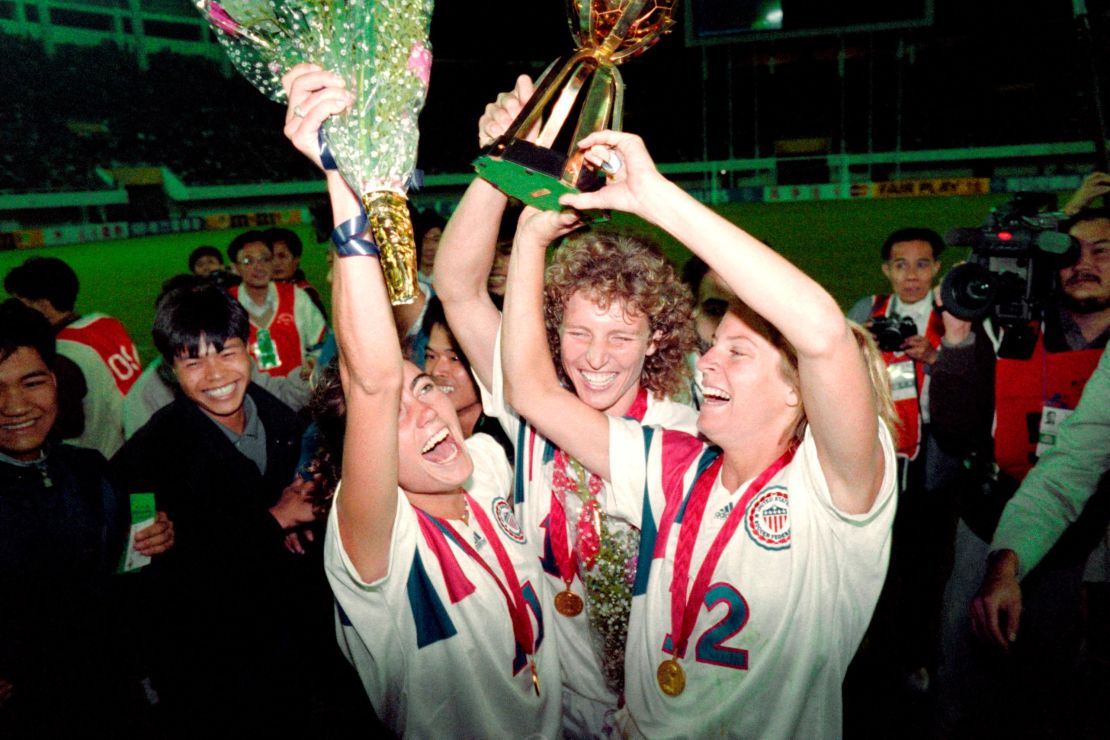 Michelle Akers-Stahl (C), Julie Foudy (L) and Carin Jennings (R) celebrate winning the first Women's World Cup held in 1991.