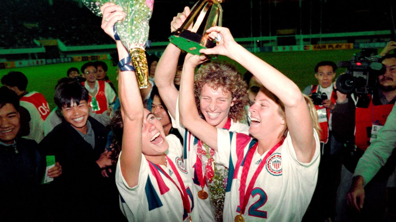 Michelle Akers-Stahl (C), Julie Foudy (L) and Carin Jennings (R) celebrate winning the first Women's World Cup held in 1991.
