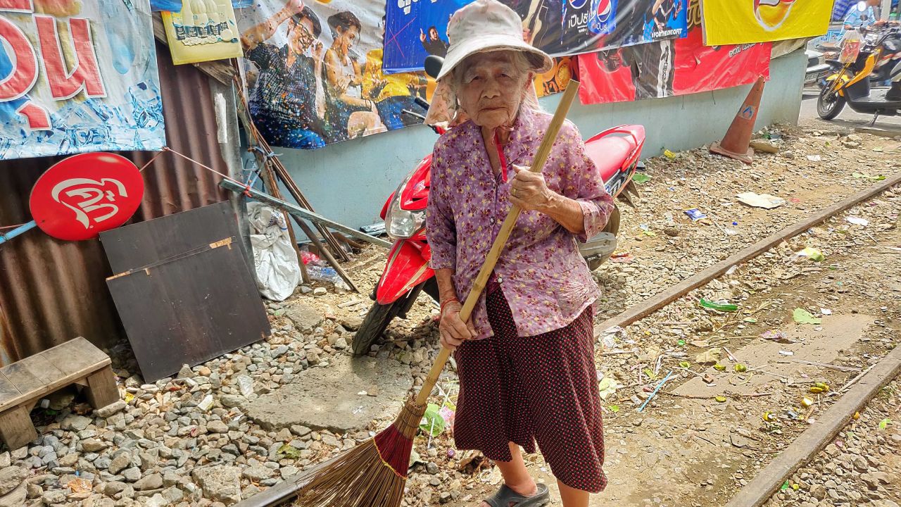 In Khlong Toei, some elderly residents volunteer as street sweepers to help keep their neighborhood clean.