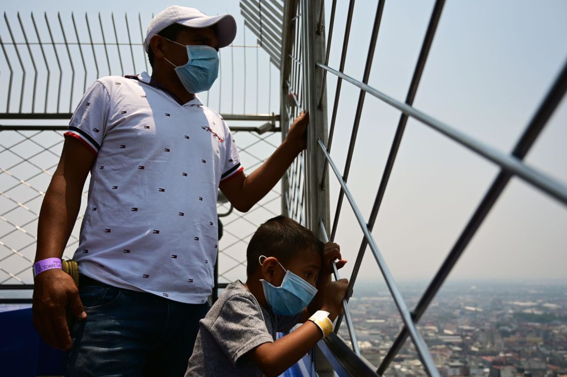 Visitors enjoy the view --despite air pollution -- from the Latin American tower viewpoint in Mexico City on May 14, 2019.