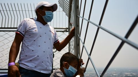 Visitors enjoy the view --despite air pollution -- from the Latin American tower viewpoint in Mexico City on May 14, 2019.