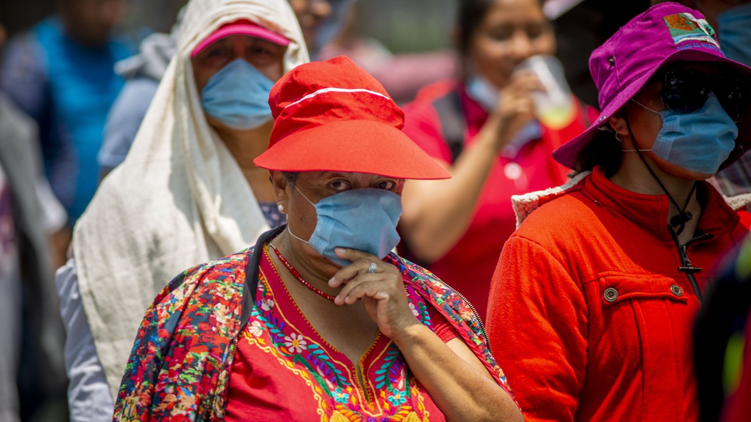 Pedestrians cover their mouths and noses in Mexico City