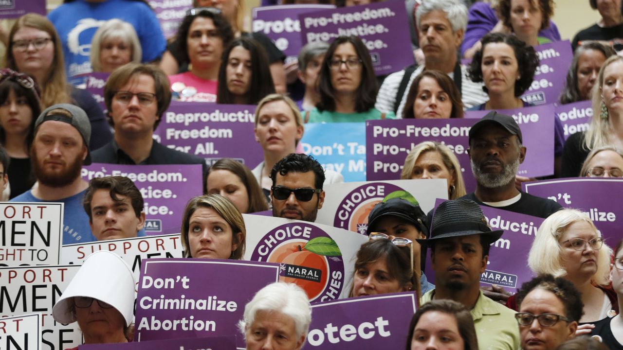 Abortion rights supporters stand during a news conference by Presidential candidate Sen. Kirsten Gillibrand, D-N.Y., at the Georgia State Capitol in Atlanta on Thursday, May 16, 2019 to discuss abortion bans in Georgia and across the country. Georgia was the fourth state this year to pass anti-abortion "heartbeat" legislation, but Democratic presidential candidates have taken aim at the state's law banning most abortions after six weeks that's set to go into effect in January. (Bob Andres/Atlanta Journal-Constitution via AP)