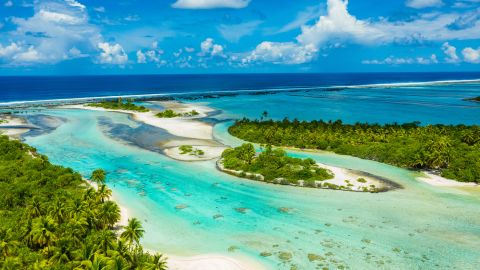 Rangiroa aerial drone video of atoll island motu and coral reef in French Polynesia, Tahiti. Amazing nature landscape with blue lagoon and Pacific Ocean. Tropical island paradise in Tuamotus Islands.