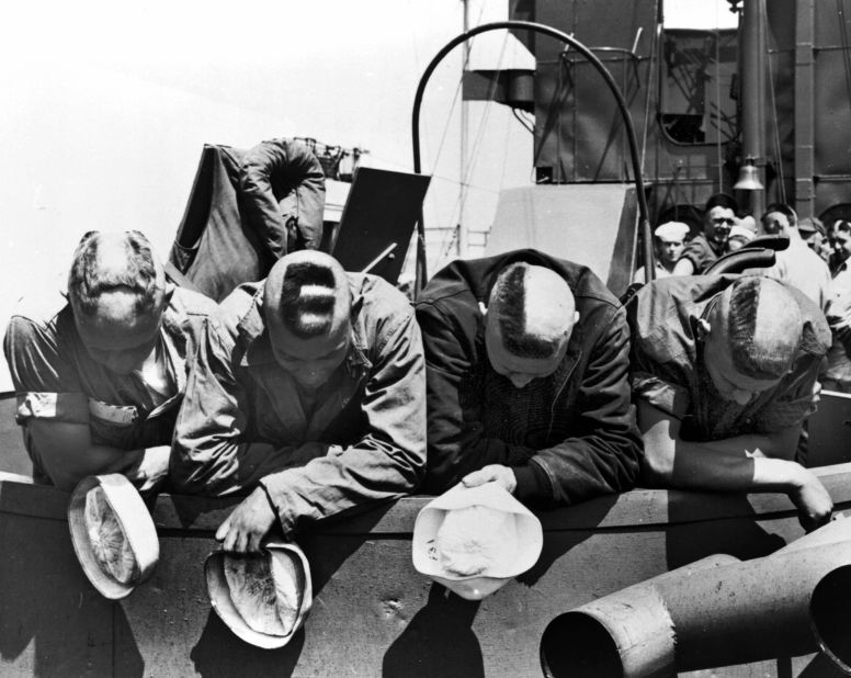 Four Americans show off their shaved heads, which spell out the word "hell," a few hours before arriving on the beaches of France.