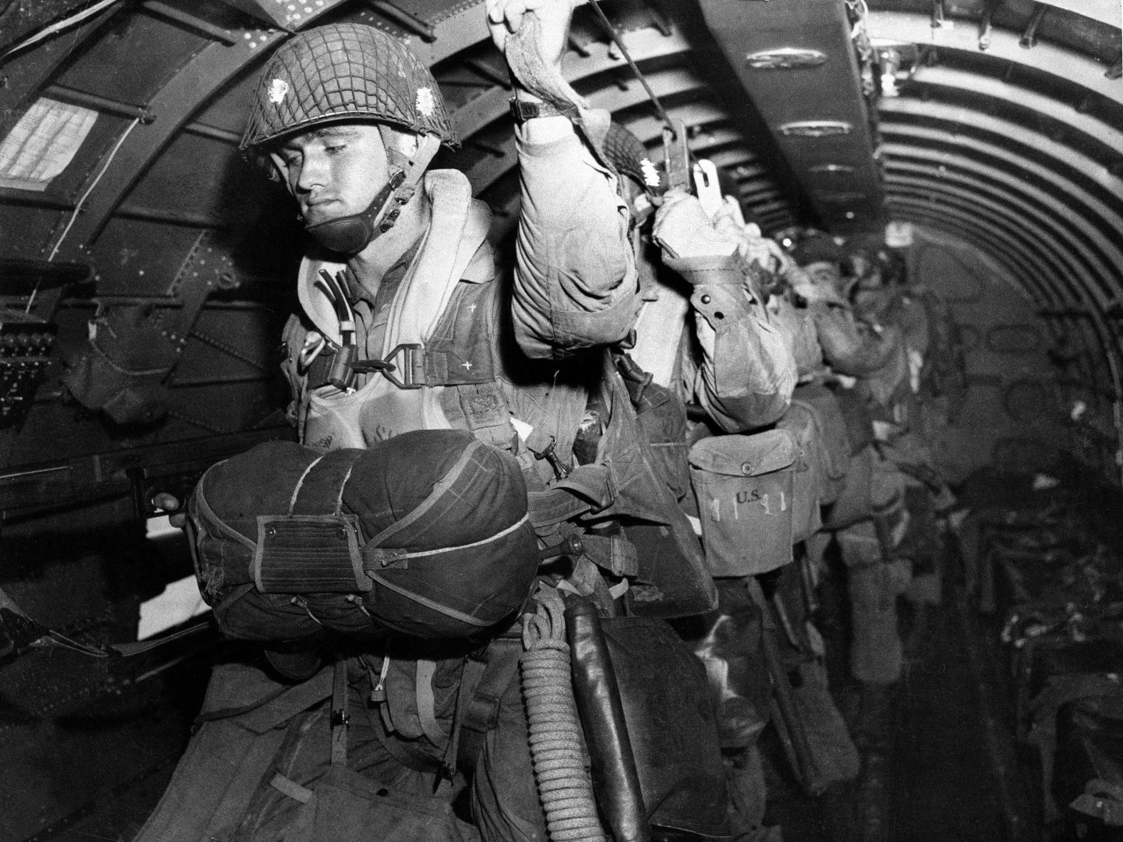 US paratroopers fix their static lines before a jump over Normandy. The Allied invasion — codenamed Operation Overlord — was coordinated across air, land and sea.