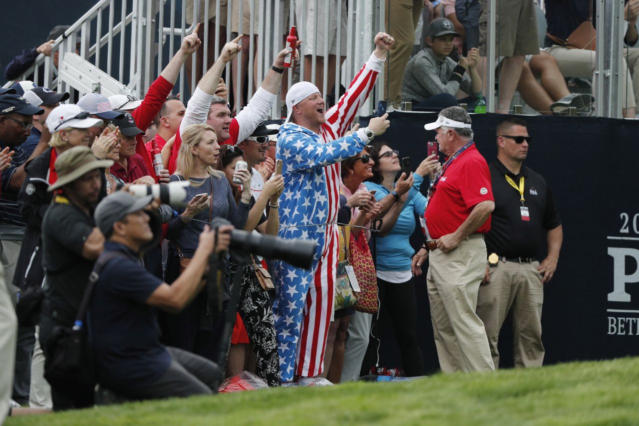Fans cheer for Tiger Woods on the 13th hole. 