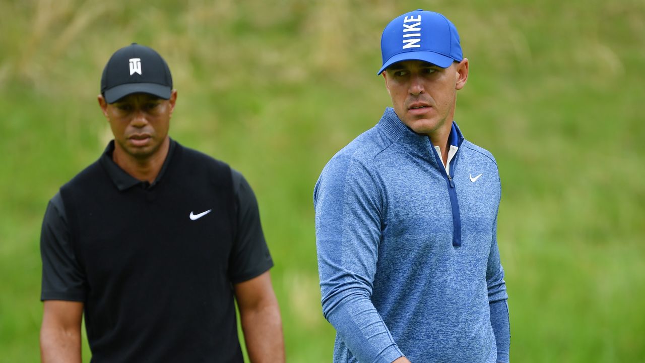Brooks Koepka (right) stamped his authority on the US PGA as Tiger Woods toiled. 